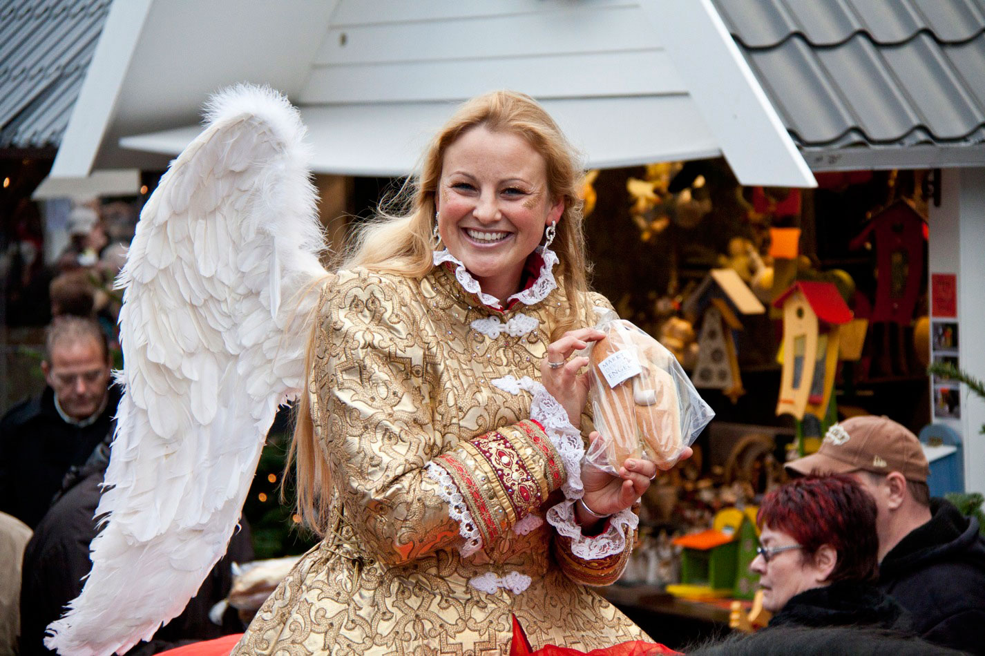 A woman dressed as an angel smiles at the Cologne Christmas market 'Markt der Engel'.