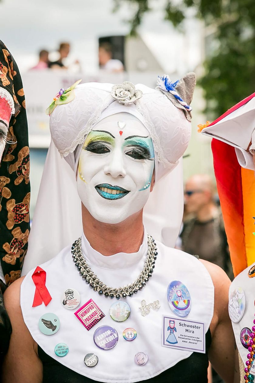 Three people in imaginative nun costumes and striking makeup pose for the camera.