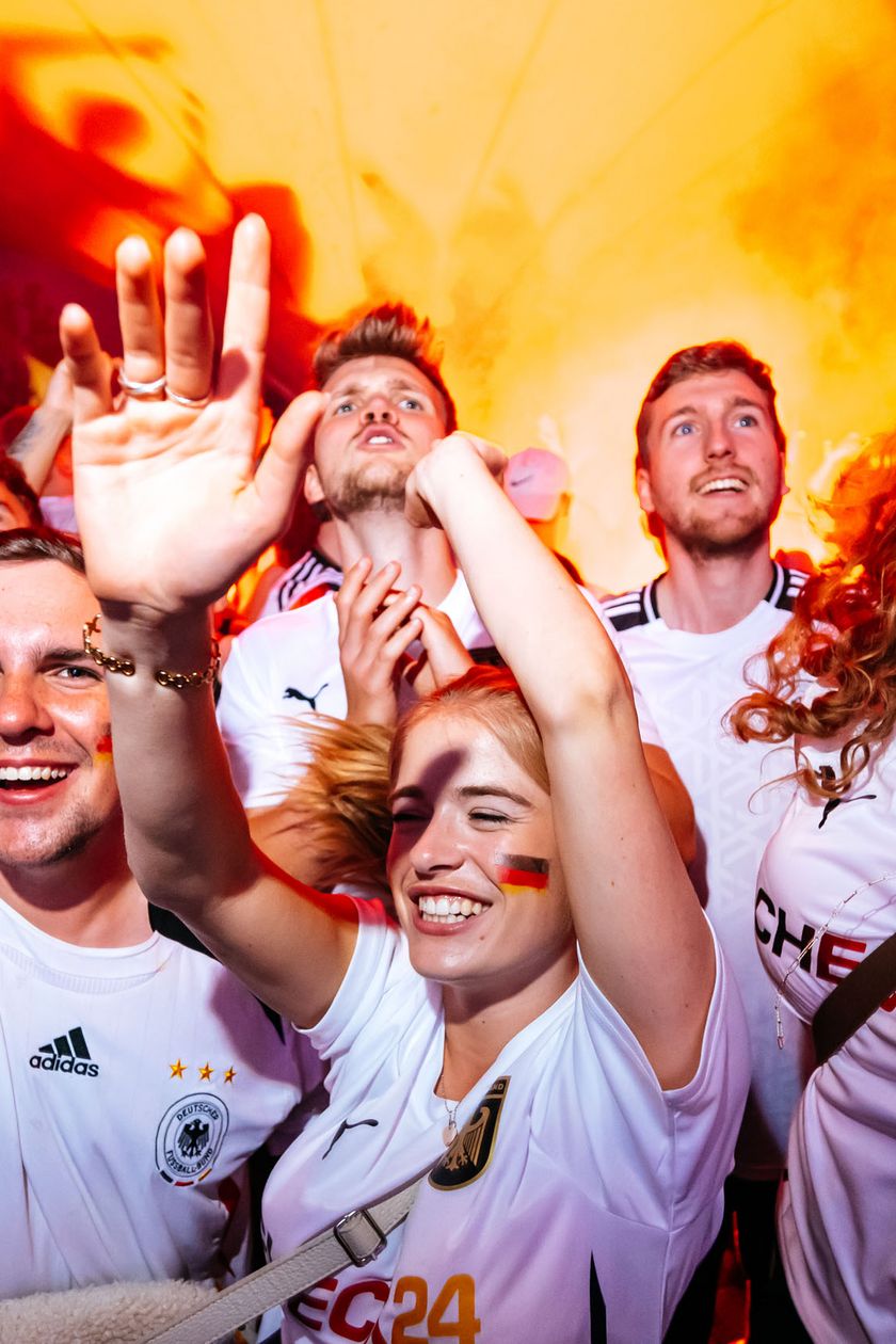 Celebrating and cheering fans wearing jerseys.