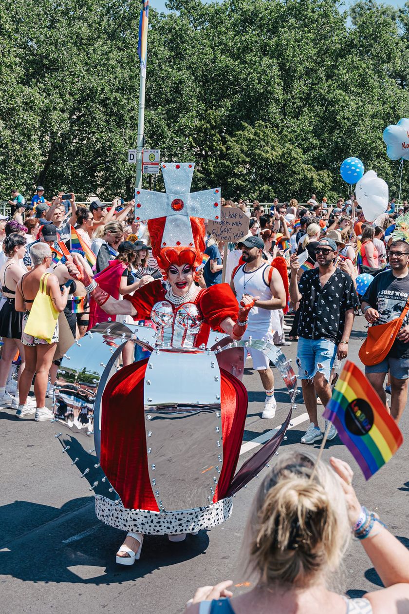 The Pride demonstration peacefully moves through the street with people in imaginative costumes.