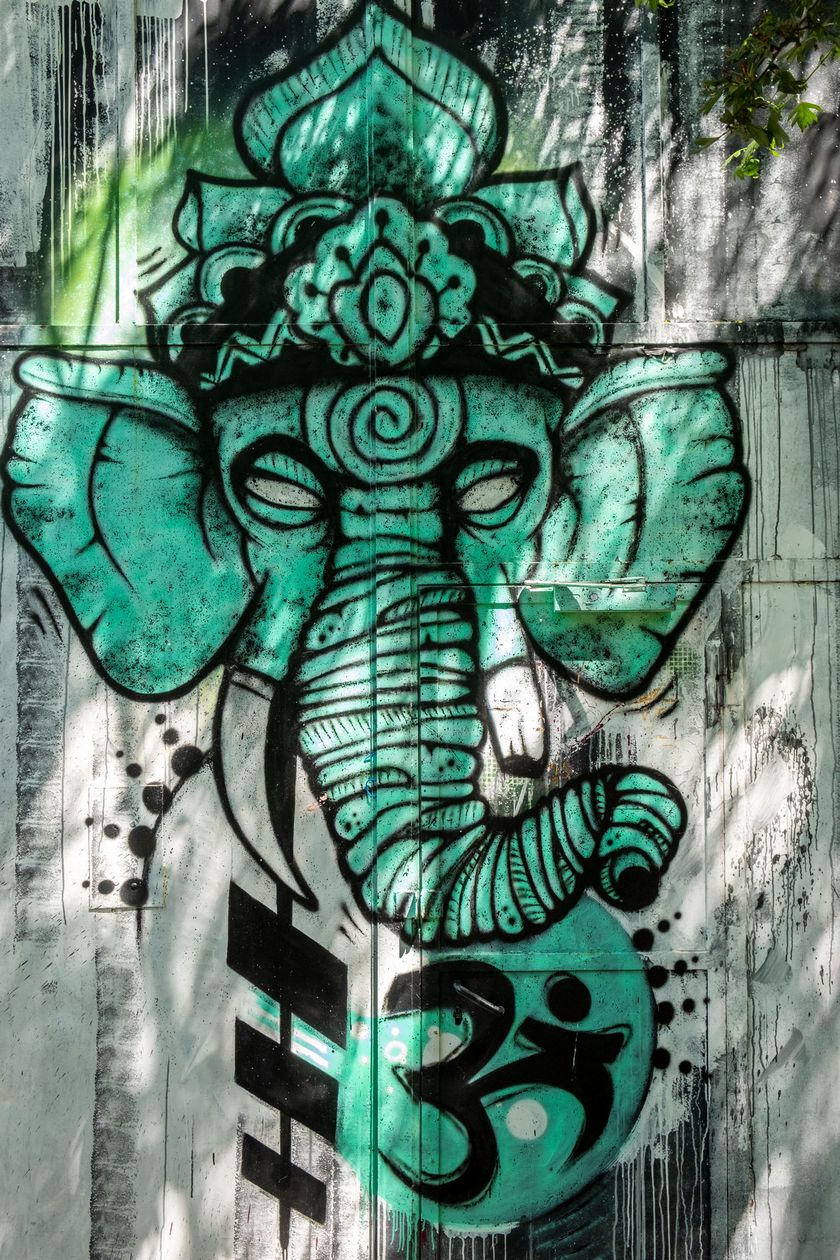 A mural shows a Buddhist elephant head in green color.
